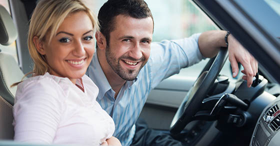 Smiling,Young,Couple,Posing,Sitting,In,A,Car